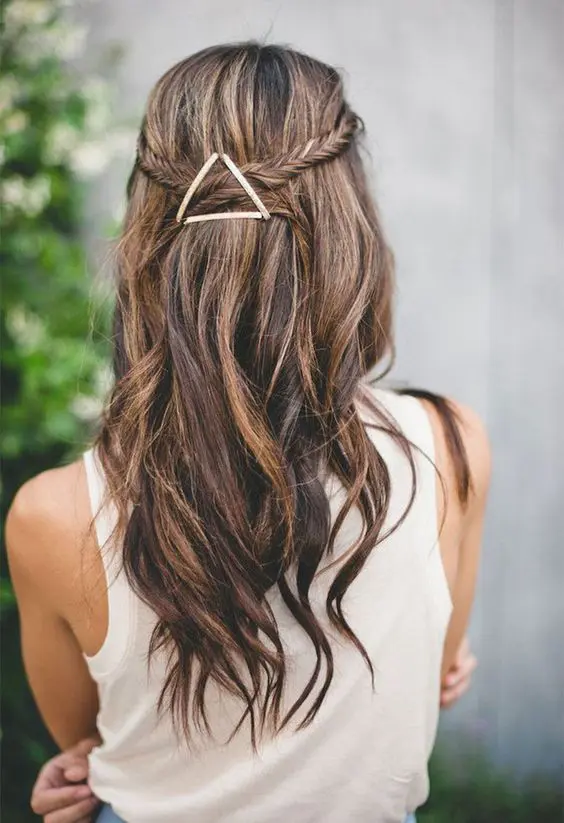 a fishtail braided half updo with waves and an eye catchy geometric hairpiece that adds a boho feel