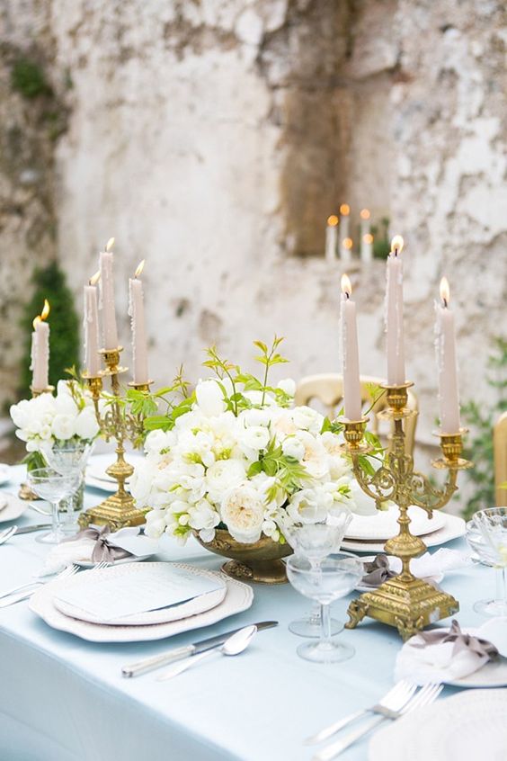 light blue textiles plus vintage gold candle holders and a vase for a refined vintage look