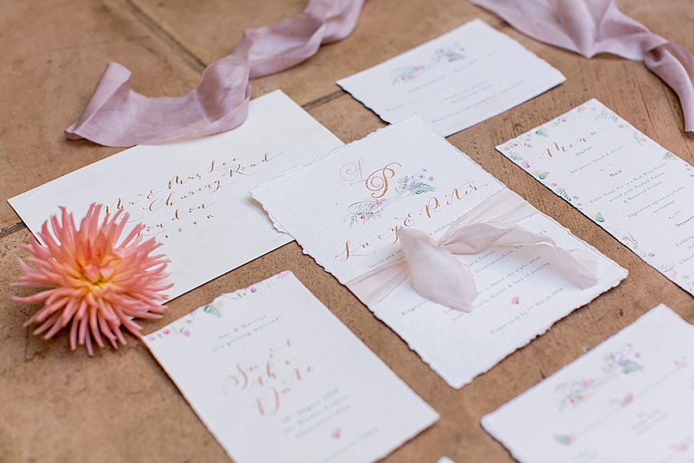 The invitation suite was done with a rough edge, with peacock feathers and botanicals