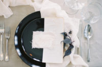 06 The place setting was done with black plates, exquisite stationery and airy fabrics