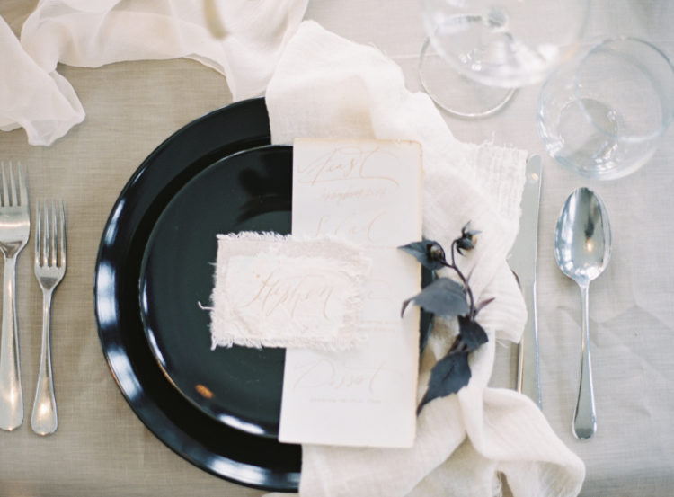 The place setting was done with black plates, exquisite stationery and airy fabrics