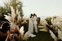 06 The wedding ceremony space was done with lush pampas grass touches