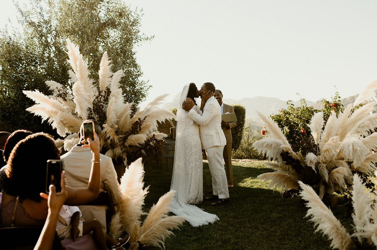 The wedding ceremony space was done with lush pampas grass touches