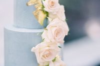 06 a chic dusty blue wedding cake with gold leaf decor and cascading blush roses