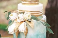 06 a wedding cake with two gold stripe tiers and one turquoise watercolor ombre plus fresh blooms