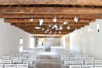06 hang some large white paper cranes above the wedding ceremony space for a cool airy feel