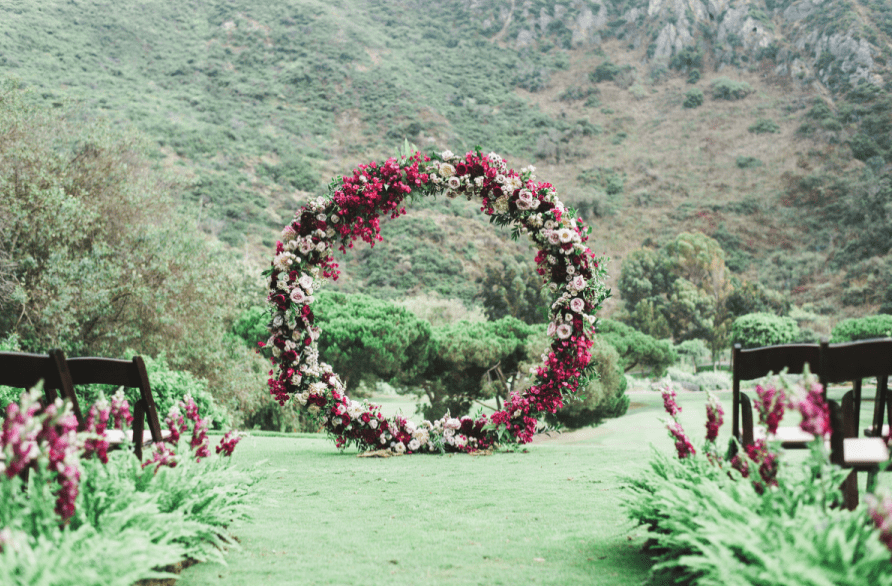 An oversized circle floral arch in jewel tones looked just wow and besides it's a hot trend