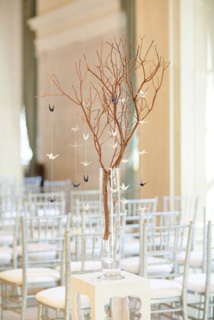 branches with little paper cranes for decorating a contemporary ceremony space