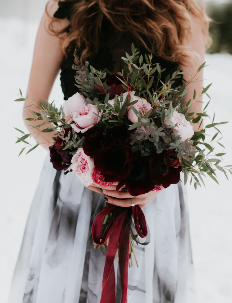 The bride was carrrying a matching bouquet with burgundy velvet ribbon