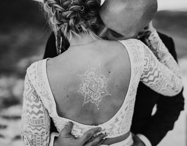 The bride was rocking a white henna tattoo on her back