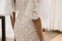 08 a refined lace sheath off the shoulder wedding dress with bell sleeves by Marchesa