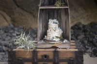 08 a wedding cake displayed a part of a boat, on a large chest with air plants