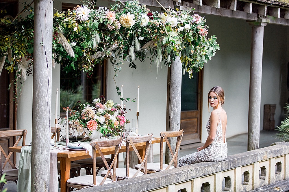 Lush boho floral decorations were created for the shoot including this one hanging over the table
