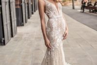 09 a mermaid wedding dress with lace appliques, a plunging neckline and a ruffled train by Berta