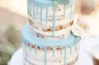 09 a naked wedding cake with mint drip and blush blooms on top
