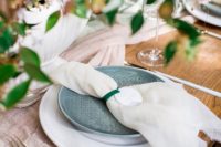 10 The table was decorated with lush florals, a blush runner and ivory napkins, green plates and neutral chargers