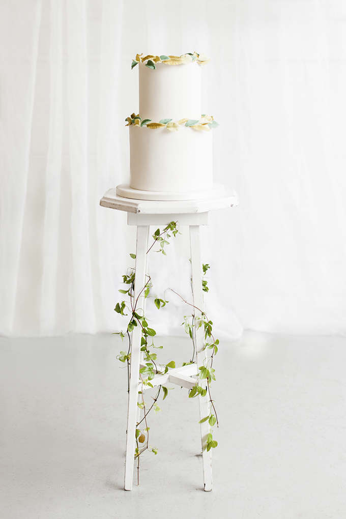 The wedding cake was a white one decorated with edible greenery in yellow and green