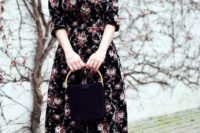 10 a black midi floral dress with short sleeves, black heels and a black bag with a gold handle