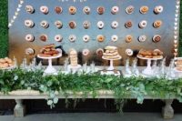 10 a polished wall with stenciled letters as a backdrop for the dessert bar