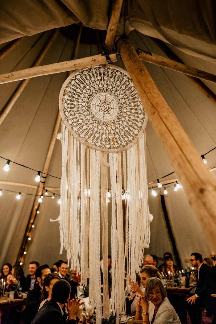 A large dream catcher was hanging in the center of the teepee