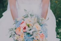 12 a bridal bouquet with blush, peachy pink and blue flowers for a pastel look