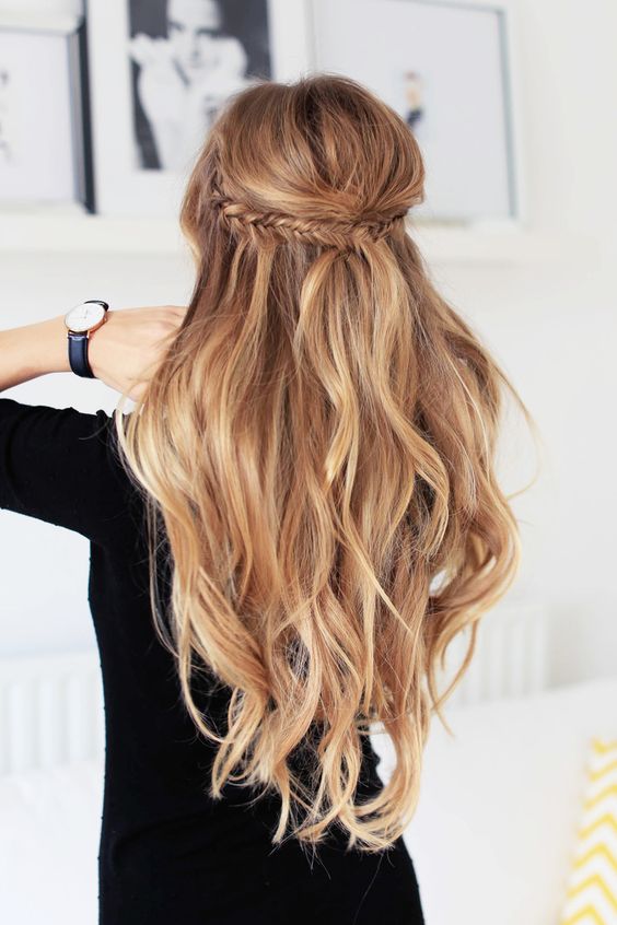 long wavy half updo with a fishtail braid and volume on top for a boho feel