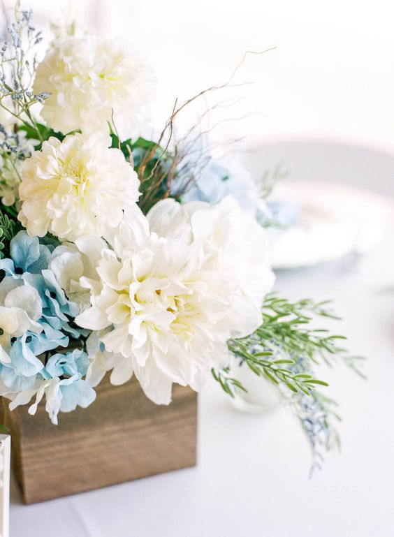 a wooden box with blue hydrngeas, white dahlias and textural greenery is ideal for a rustic wedding