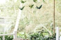 13 green paper cranes hanging over the reception tables will add a quirky touch to the space