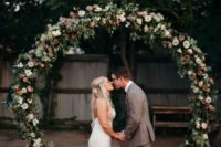 14 an oversized circle floral and greenery arch for a boho chic wedding