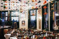 14 colorful paper cranes hanging over the whole wedding reception