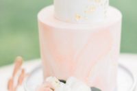 15 a marbleized peach pink and white wedding cake with gold leaf decor for a glam touch
