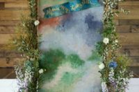15 a very bold watercolor wedding backdrop with greenery and blooms on both sides plus lanterns