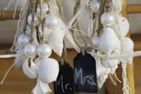 15 shells and oversized pearls on ropes with chalkboard tags are great for a pirate wedding