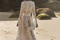 16 a gypsy-inspired boho lace wedding dress with a V-neckline, bell sleeves and a train