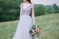 16 a lavender wedding gown with a lace embellished bodice, a V-neckline and a layered skirt