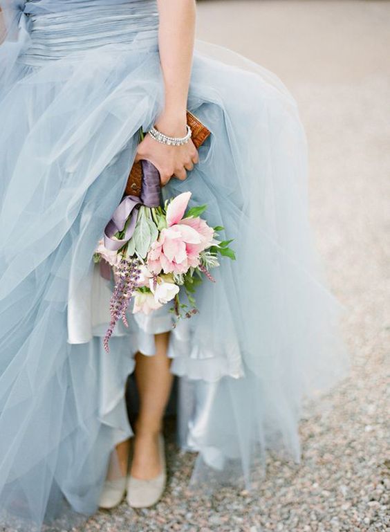 a light blue wedding dress and a pink wedding bouquet