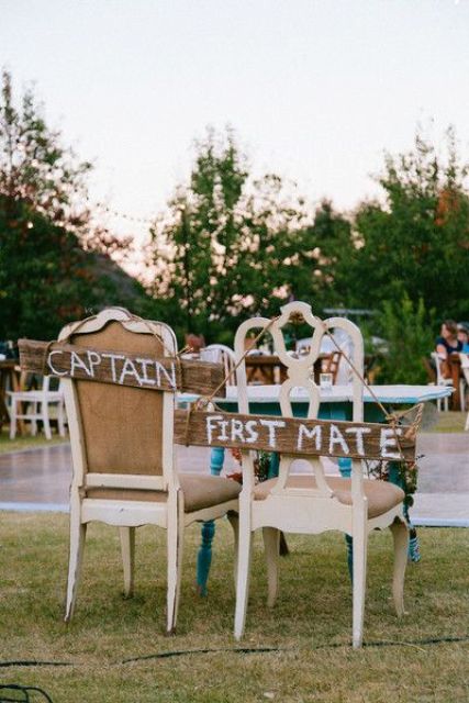 the couple's chairs decorated with wooden plaques Captain and First Mate