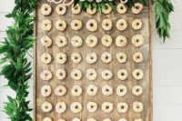 17 a lush greenery garland with calligraphy letters on the donut wall