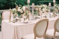 17 an al fresco table setting with blush details, florals and candles