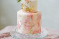 18 a pink and coral gilded watercolor wedding cake with a pink bloom and some leaves on top