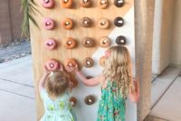 18 color block painted donut wall decorated with greenery and blooms