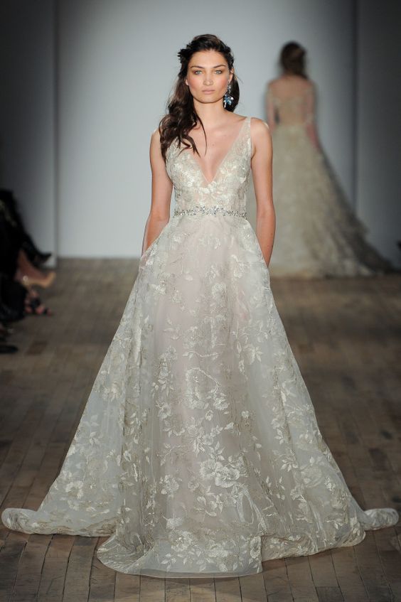 a sparkly floral print wedding gown with wide straps and a plunging neckline, an embellished belt by Lazaro