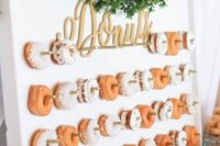 20 a fresh boxwood garland and calligraphy letters for highlighting the donut wall