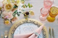21 a table setting with pink and amber glasses, with a gold edge charger and gold and pink blooms