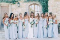 21 bridesmaids wearing baby blue dresses and carrying white bouquets
