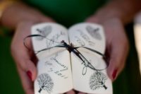 21 origami wedding program with a black ribbon bow for a fun feel