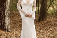 22 a lace wedding gown with a V-neckline, bell sleeves and a highlighted waist
