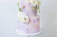 22 a pastel watercolor wedding cake topped with fresh white flowers