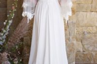 23 a long boho lace dress with a V cut back, long bell lace trim sleeves and a train