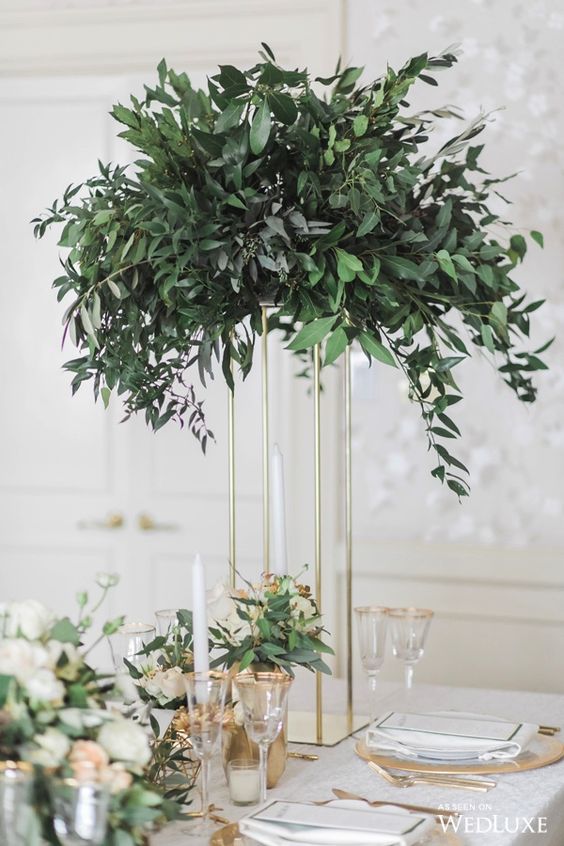 a tall eucalyptus centerpiece on a gilded frame to save some table space